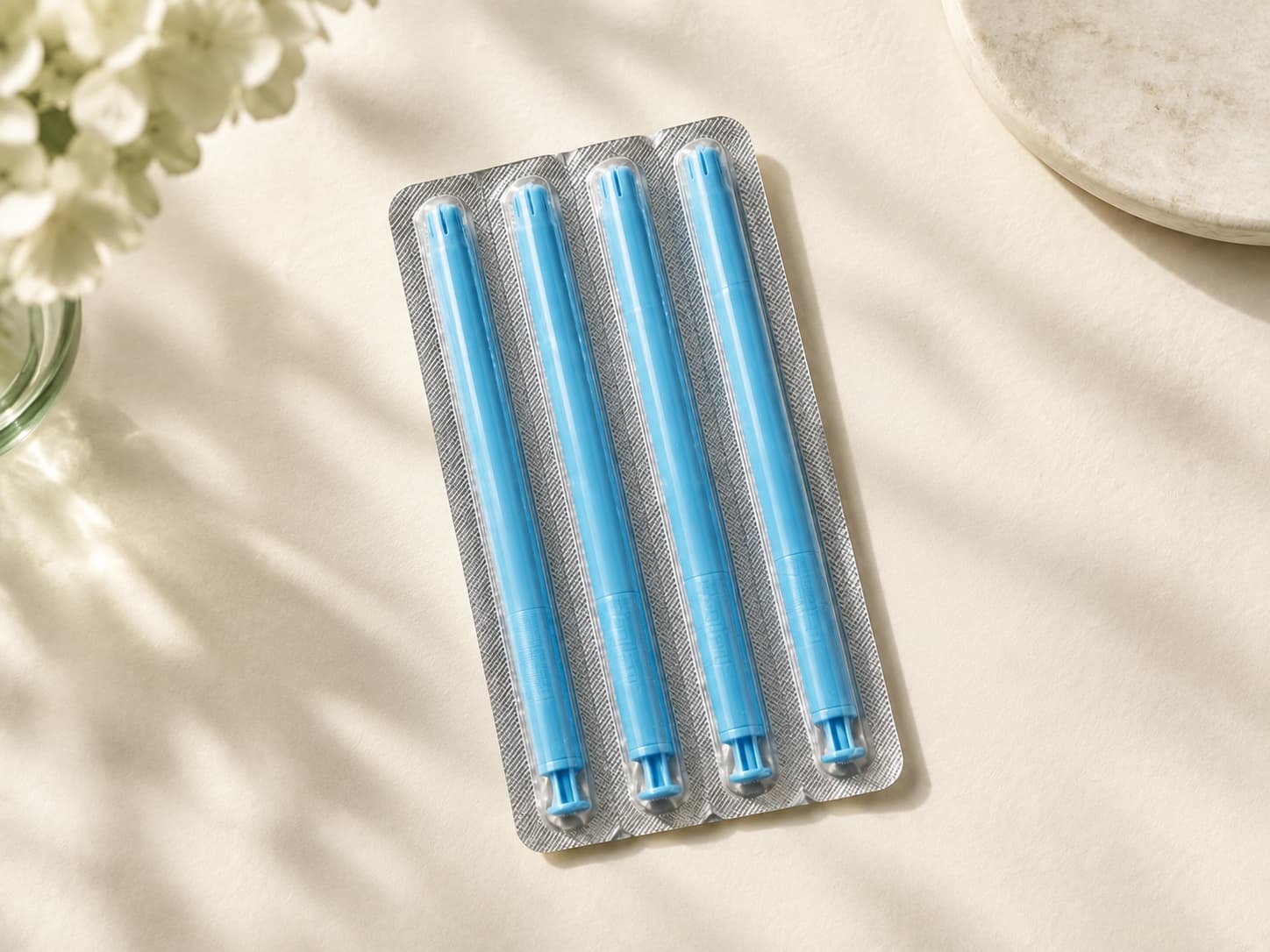 Three single-use vaginal estradiol insert applicators in blister packs